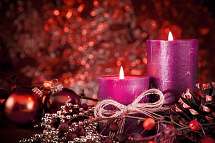 two pink pillar candles, Christmas ornaments , candles