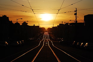 street between parked vehicles and building digital wallpaper, railway, sunset