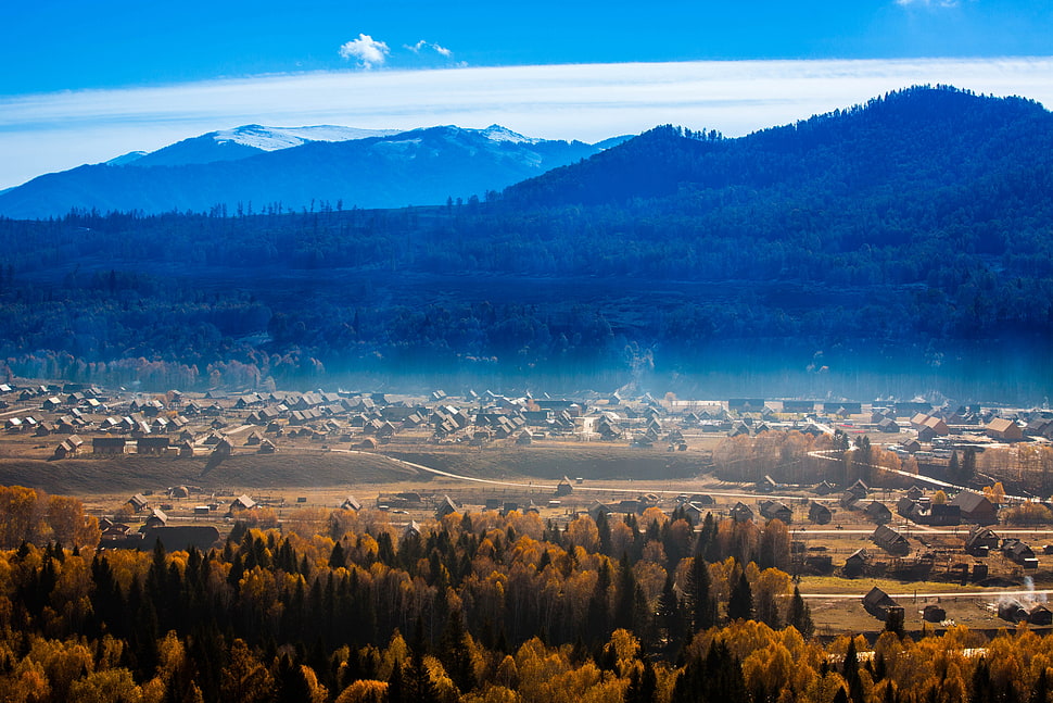 mountain in front the farm during daytime HD wallpaper