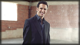 photography of man wearing gray formal coat taking selfie