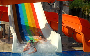 person sliding on a multicolored slide