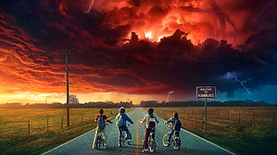 four children riding their bikes on high way