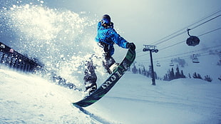 man riding snowboard