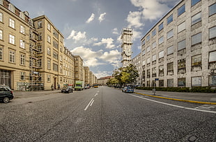 architectural photography of high-rise buildings near road full of cars, aarhus