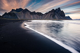 black sand seashore and gray mountain