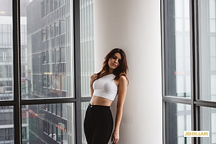 woman in white halter crop-top and black pants