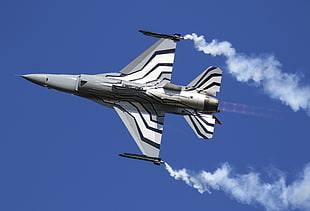 gray and white fighter jet flying under blue sky during daytime