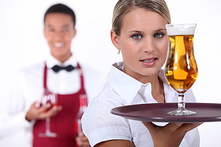 woman holding tray of beer
