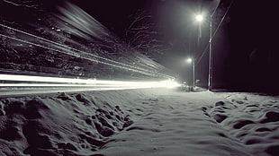 timelapse photography of snow-covered pathway during night time