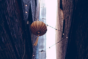 round brown hanging decor with string lights, urban, city, street, wall