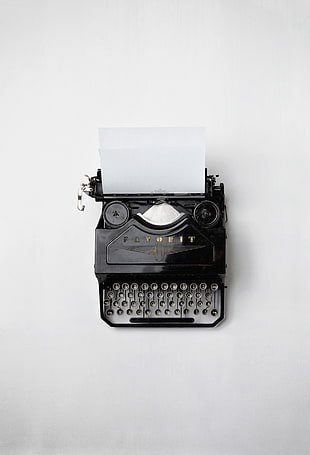 black Favorit typewriter with white printer paper HD wallpaper