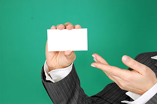 person holding white card