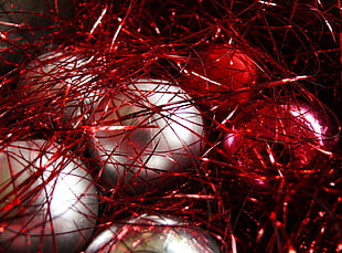 shallow focus photography of three gray and two red Christmas baubles
