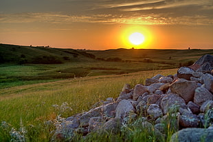 sunset scenery at the farm with stack of gray rocks