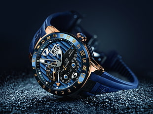 round black and blue case chronograph watch with strap on cloth