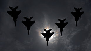 silhouette photo of five fighter planes