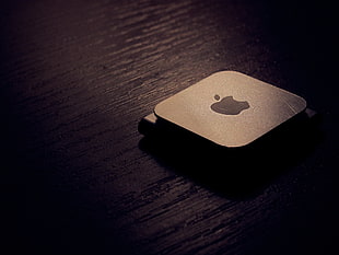 6th generation gray iPod nano on top of brown wooden surface