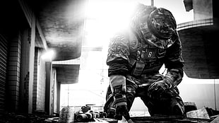 grayscale photo of soldier beside building
