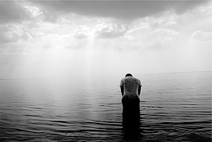 person standing in calm sea