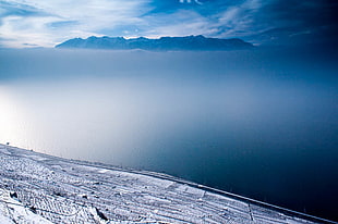 top view of body of water and mountain under blue and white sky, léman