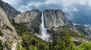 waterfalls surrounded by mountains