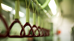 selective focus photo of brown train passengers handle