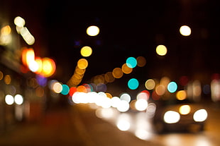 blurry photo of gray car on concrete pavement road during night HD wallpaper