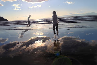 two person hands on pocket walking on beach illustration