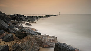 photo of sea shore with rock formation