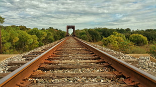rusty gray metal train rails close up photo
