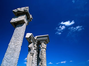 three concrete pillar stand