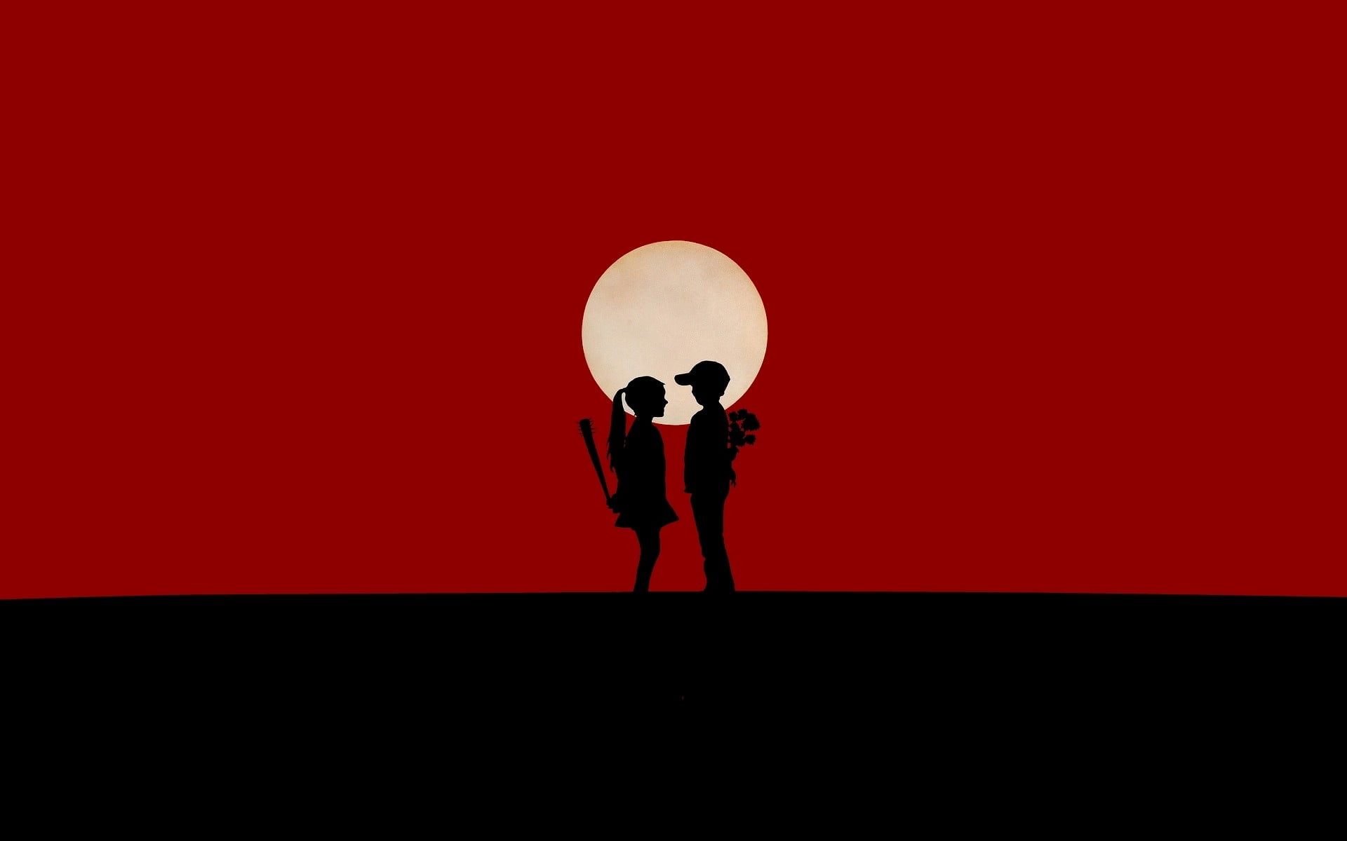 silhouette of boy and girl standing on moon