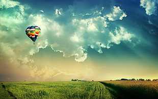 multicolored hot air balloon, hot air balloons, field, clouds, nature HD wallpaper