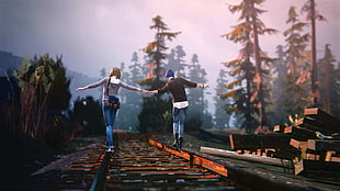 couple holding hands standing on train tracks between tall trees taken during daytime