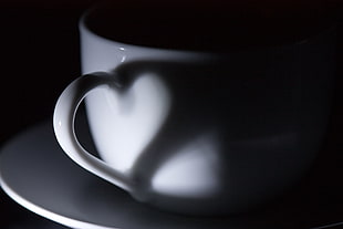 white ceramic coffee mug with heart handle shadow
