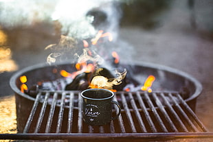 black mug on charcoal grill