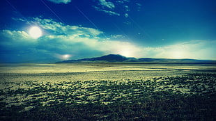 landscape photography of sun mountain and field