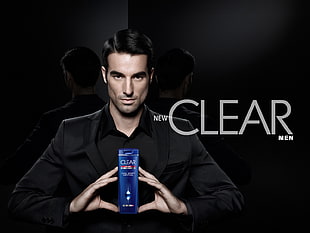 man holding Clear shampoo bottle