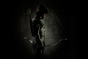 man in green and black leather jacket holding bow arrow
