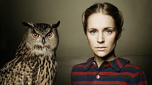 woman beside brown owl photo