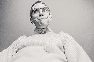 grayscale photography of man in white turtleneck sweater