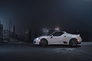 white sports coupe at nighttime
