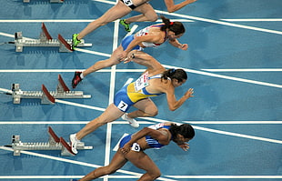 four people doing track and field