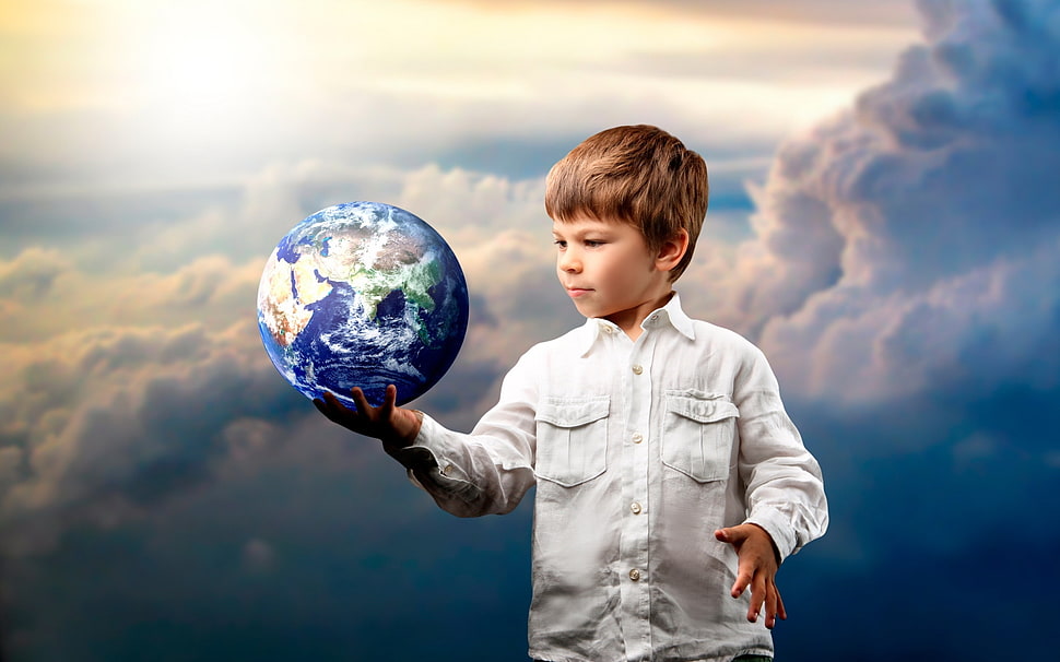 boy holding the Earth scale model at the white clouds HD wallpaper