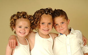 two girls and one boy wearing white portrait photo