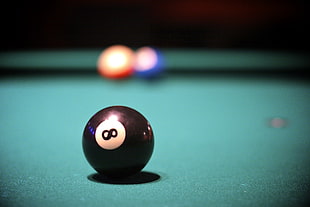 selective focus photography of 8 billiard ball on table