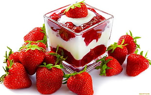 strawberry on top ice cream served on clear glass bowl