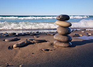 five balance stone on beach line