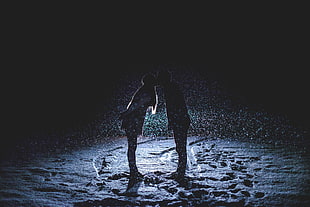 silhouette photo of woman and man kissing