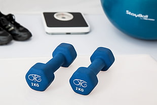 two 2kg fixed weight dumbbells on white surface